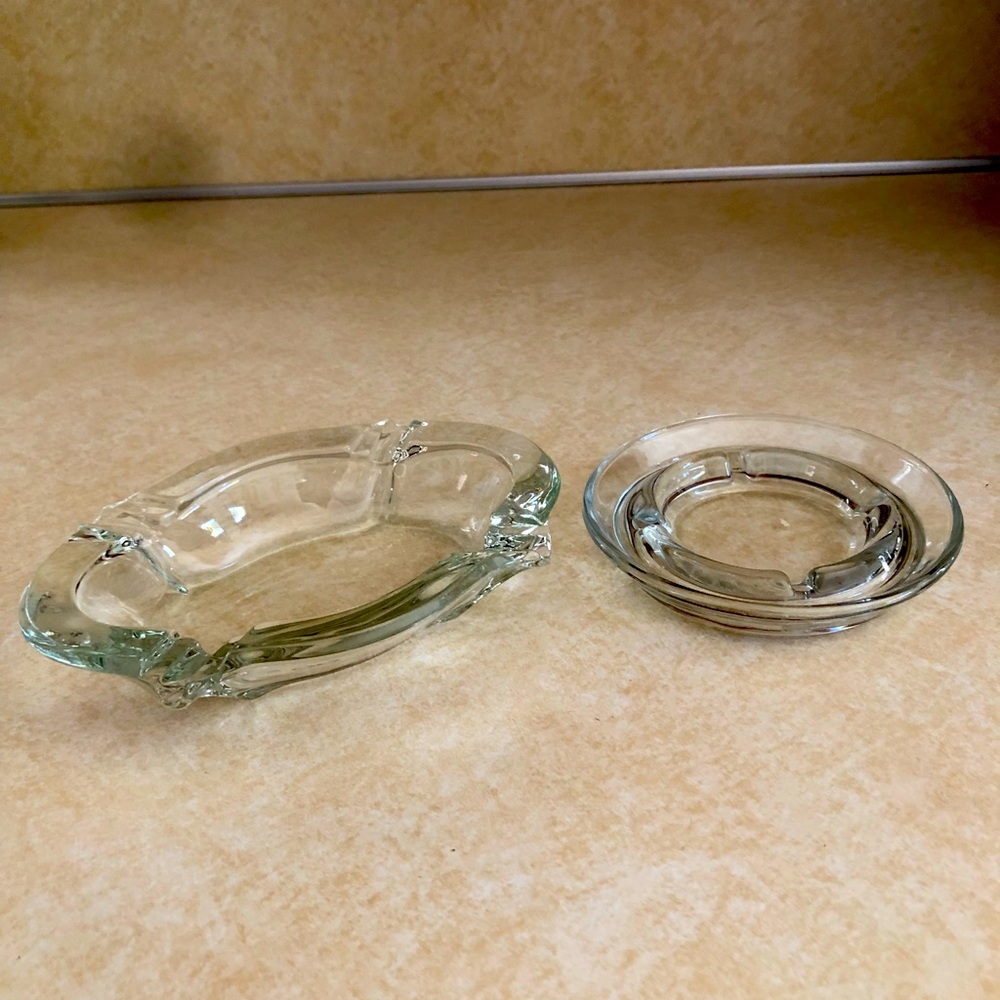 Two vintage clear glass ashtrays.
